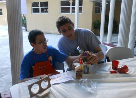 Junior, Evan Kravetz builds an art project with his friend, Javier. Photo by Jessica Szmuler. 