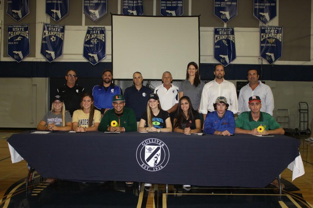 Athletes sign letters of intent on Nov. 9 at the Prep gym.  From left to right:  Lilly Barlow, Brooke Ellis, Raymond Gil, Shannon Kunkel, Sarah Lobo, Christian Nido, Robert Touron.  Back Row:  Softball Coach Mark Schusterman, Swim Coach Christopher George, Girls Basketball Coach John Zambolla, Girls Volleyball Coaches Ed Potter and Suzanne Landsom, Baseball Coach Manny Crespo.