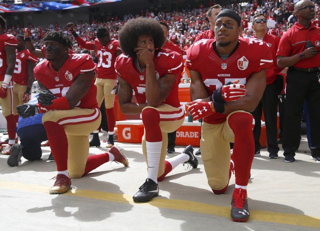 From left, The San Francisco 49ers Eli Harold (58), Colin Kaepernick (7) and Eric Reid (35) kneel during the national anthem before their a game against the Dallas Cowboys on October 2, 2016, at Levis Stadium in Santa Clara, Calif. (Nhat V. Meyer/Bay Area News Group/TNS)