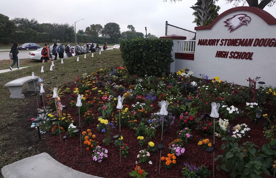 Students walk past the new memorial garden outside of Marjory Stoneman Douglas High School in Parkland, Fla., Monday, Jan. 14, 2019.  (Joe Cavaretta/South Florida Sun Sentinel/TNS)