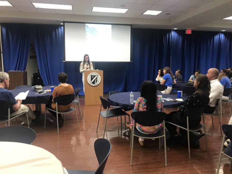 Senior Olivia Hernandez reads an excerpt from her most recent novel at Gulliver Writes. The NEHS board selected a wide variety of student-written pieces to feature. The event took place in the student union on Apr. 10. Photo by Lara Russell-Lasalandra  