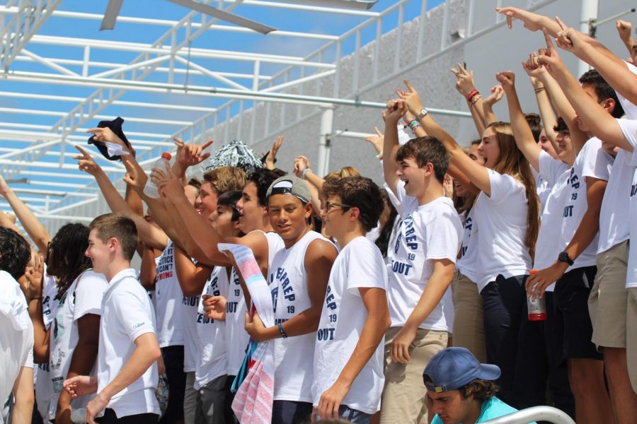 Fans cheering during the football game wearing all white. Students got free T shirts to wear, and the stands were charged with energy. Photo by Julian Concepcion. 