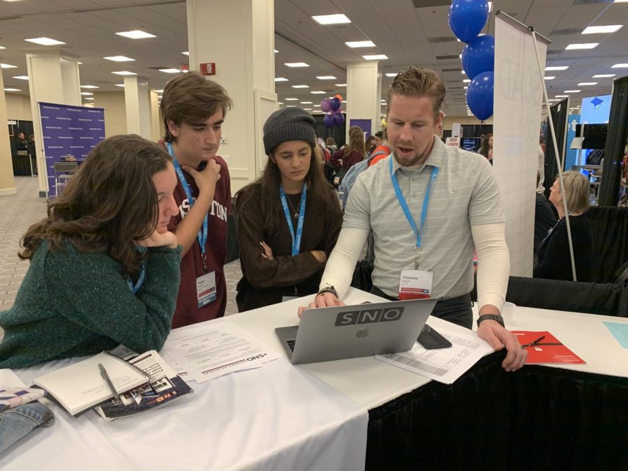 Junior Pedro Schmeil and sophomores Kathleen Lewis and Teresa Ariza work with SNO design consultant Thomas Sugatt at the 2019 NSPA Fall Convention in Washington, D.C. Sugatt worked with them on website design. Photo by Monica Rodriguez