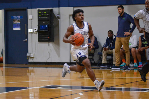 Senior Gabe Taylor, steals the ball and drives it in for an easy bucket. Taylor averages an impressive 3.8 steals per game. Photo by Fox Mar.