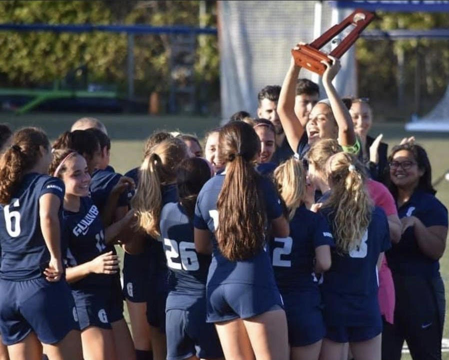 The girls varsity soccer team celebrates after winning a district championship on Wednesday. The team fought hard to defeat Mast Academy 3-0, and will move onto the regional tournament next week. Photo by David Hartnett.
