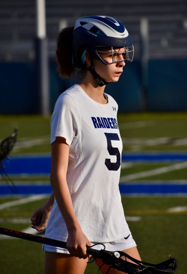Senior Laura Attarian is locked in the game and figuring out ways she can score. This is one of the six games the girls lacrosse team played before the Coronavirus pandemic. Photo by Jen Uccelli.