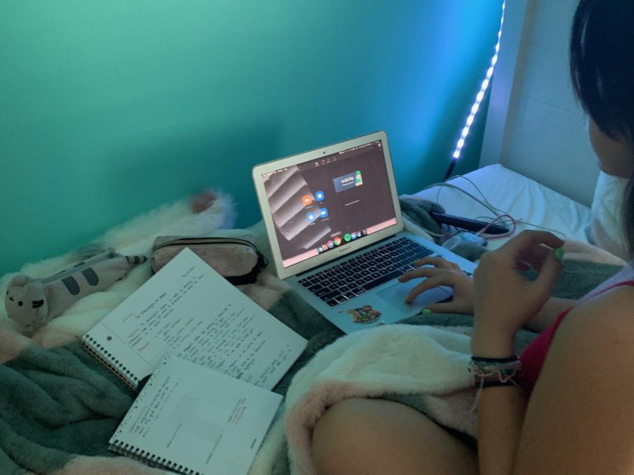 Sophomore Miranda Rodriguez does virtual schoolwork from her bedroom. Despite being able to see classmates and teachers on Zoom and communicate remotely, online school just isnt the same as seeing people in person. Its crucial that everyone respects social distancing rules and safety guidelines so that we can return to school as soon as possible. Photo provided by Miranda Rodriguez.