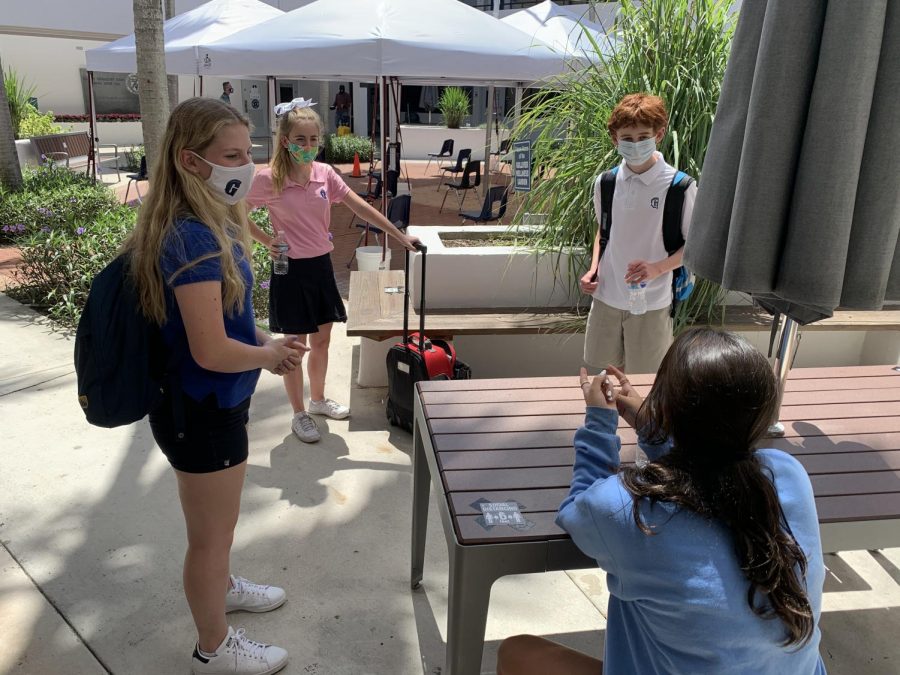 Freshman students have a socially distanced conversation before class starts.