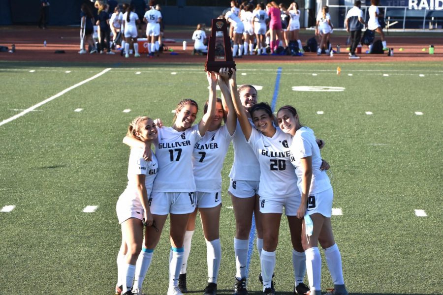 Seniors on the girls varsity soccer team celebrate after their district final game against Key West. Despite numerous setbacks, both the girls and boys teams claimed district championships and continue their season into regionals.