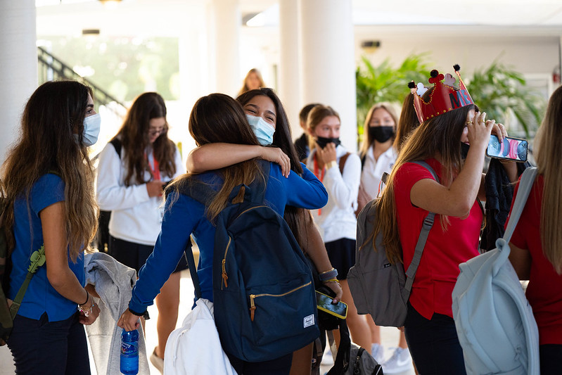 Students embrace as they arrive to campus on the first day of school. For some students, a year and a half went by before they could see their friends in-person at school.
