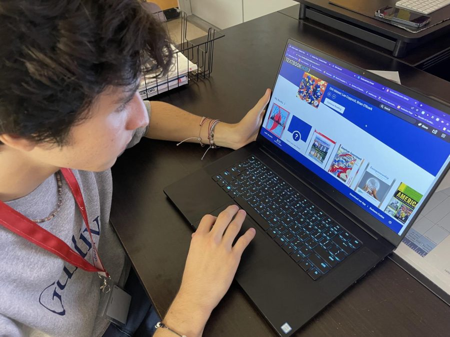 Senior Paulino Mercenari prepares to study for his AP Environmental Science class as he loads up the necessary textbook on TextBook Hub. For Paulino having digital books is much easier to manage. 