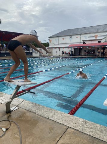 Freshman Juanfrancisco Gudino prepares to dive to swim a 50 butterfly in the 200 medley relay. The Raiders emerged with success from their meet against Miami Country Day and Carrollton last Thursday.