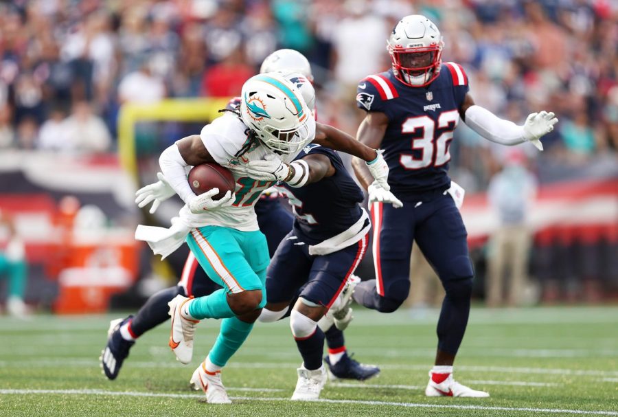 Jaylen Waddle (17) of the Miami Dolphins runs with the ball after a reception against the New England Patriots at Gillette Stadium on September 12, 2021 in Foxborough, Massachusetts.