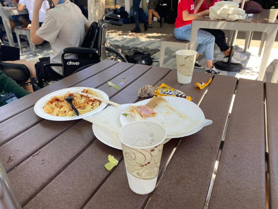 It is not uncommon to find the outdoor tables still covered with abandoned plates and cups after a lunch period ends. Students leaving behind trash and messy lunch tables has become a major problem on campus.