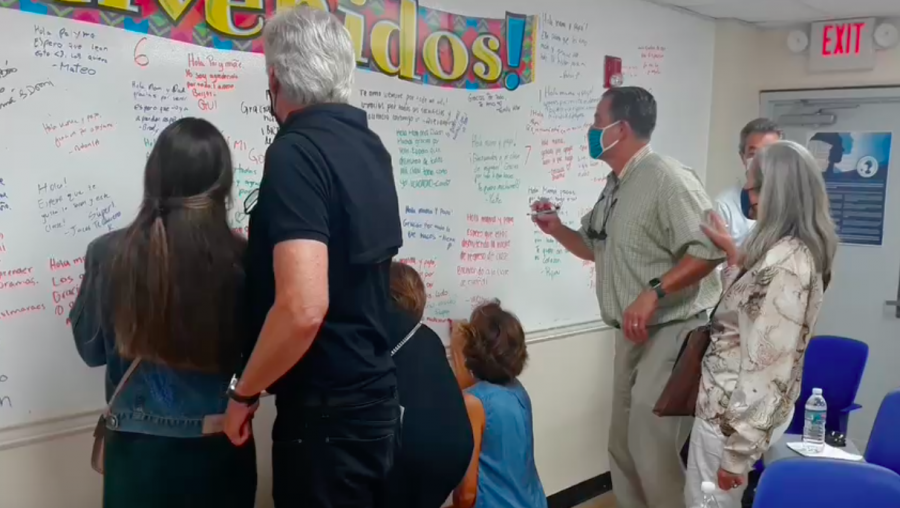 Parents write on the welcome wall during Back-to-School Night.