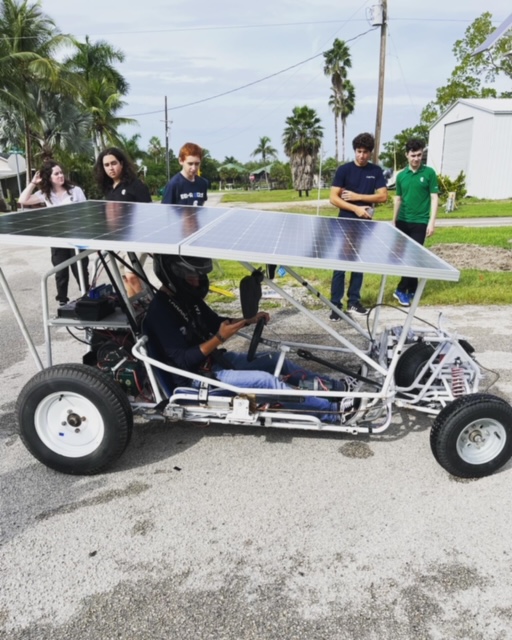 Members of the robotics team test their solar powered car in Everglades City on Oct. 25.