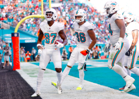 The Dolphins celebrate after scoring a touchdown against the Giants on Sunday, with a final score of 20 – 9.