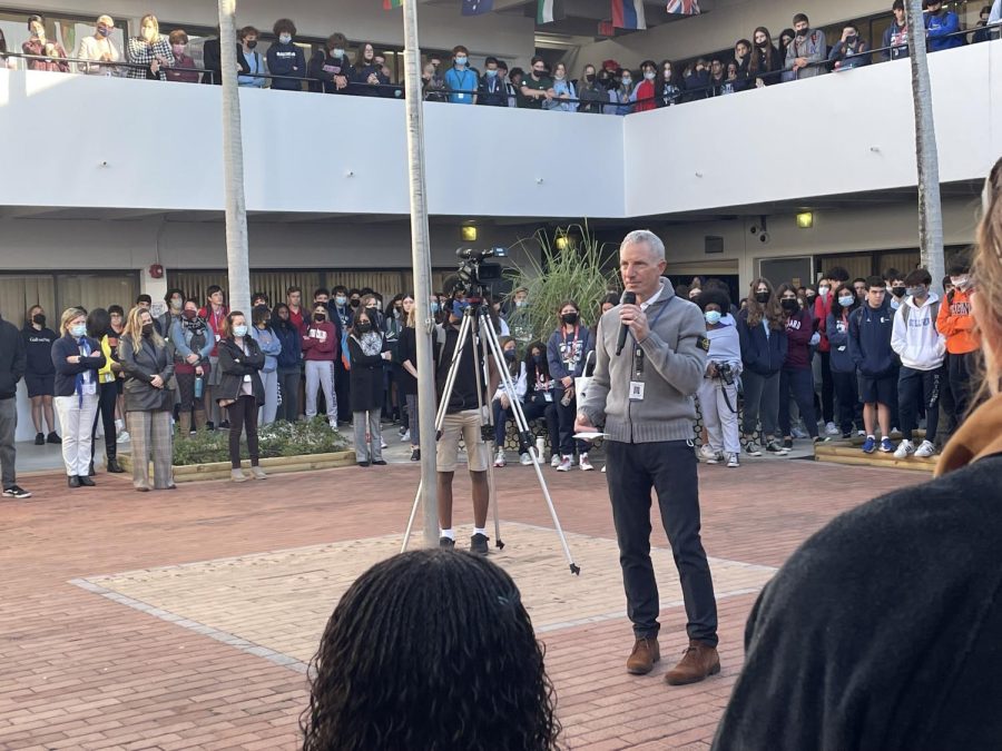 Principal Jonathan Schoenwald addresses the school during a moment of silence on Tuesday, Jan. 17 held for the passing of English teacher Juli Gerlach.