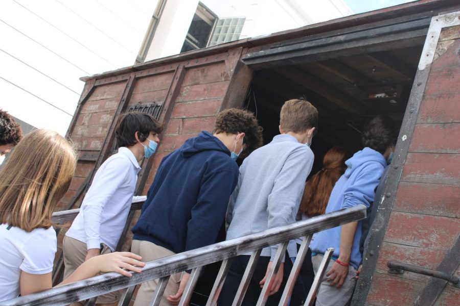 Students board the cattle car replica, where they watched a solemn presentation about the Holocaust and its legacy.