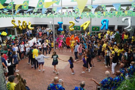 Students held hands and danced around the circle with Samba dancers to live music.