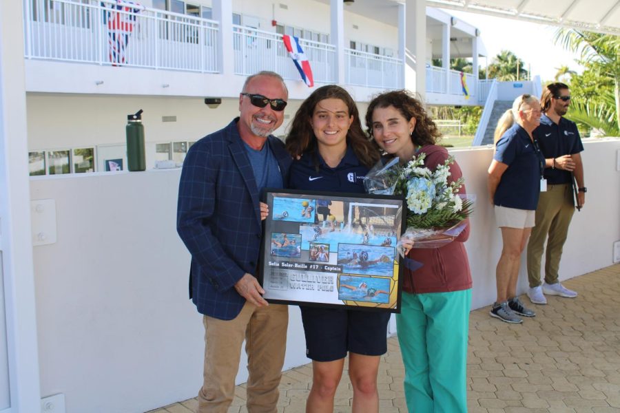 Senior Sofia Soler-Baillo poses with her parents after the girls water polo Senior Day ceremony.