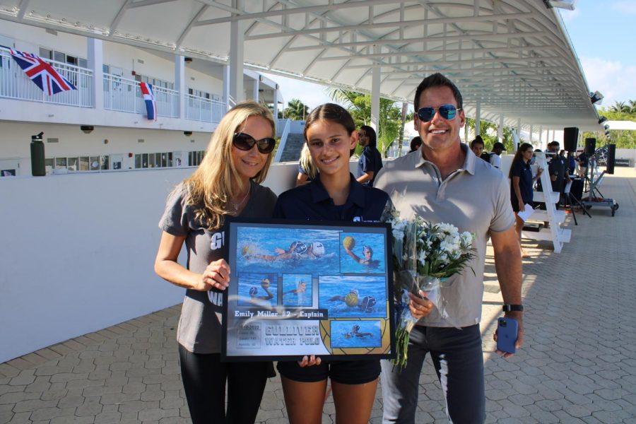 Senior Emily Miller poses with her family after the girls water polo Senior Day ceremony.