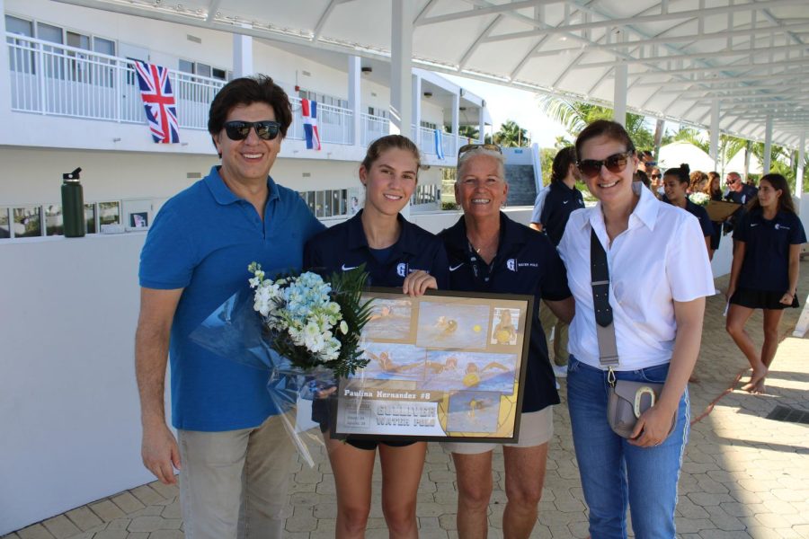 Senior Paulina Hernandez poses with her family after the girls water polo Senior Day ceremony.