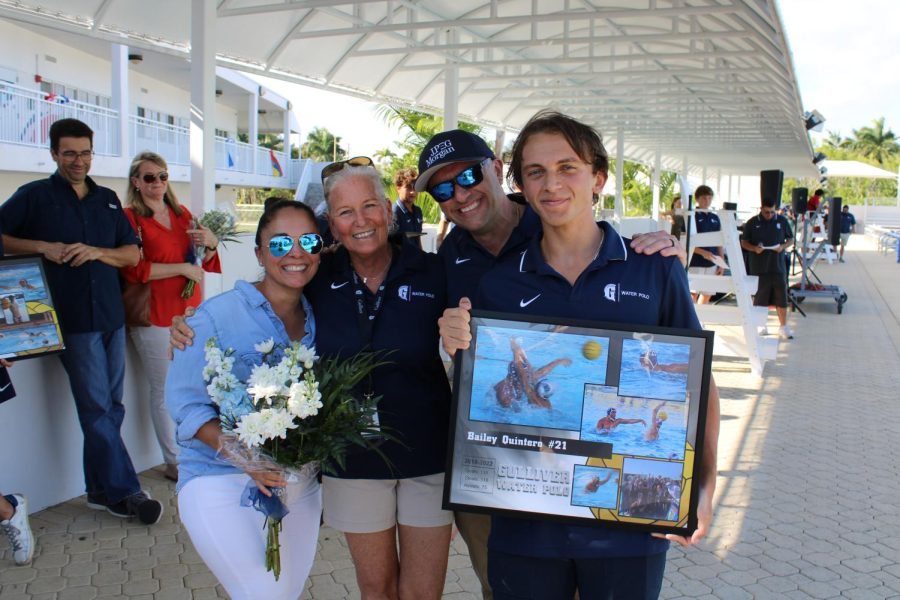 Senior Bailey Quintero poses with his family after the boys water polo Senior Day ceremony.