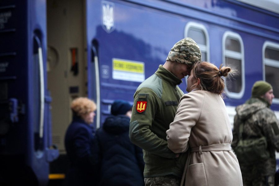 A Ukrainian serviceman says goodbye to his girlfriend before departing in the direction of Kyiv at the central train station in the western Ukrainian city of Lviv on March 9, 2022, amid the ongoing Russian invasion of Ukraine.
