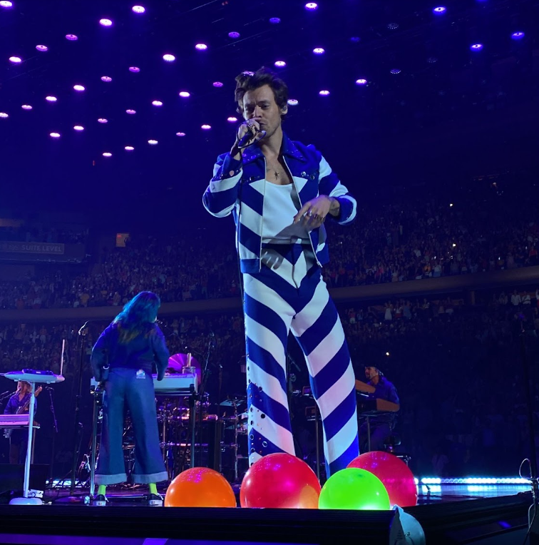 Harry Styles sings over the screams of the crowd.