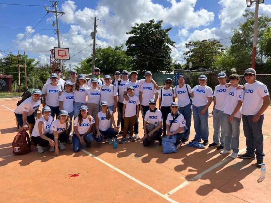 Ariana Kaye stands alongside other volunteers from the TECHO mission in the Dominican Republic after helping to build a house for the people of the underprivileged community. 