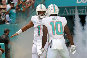 Miami Dolphins quarterback Tua Tagovailoa and wide receiver Tyreek Hill take the field for their game against the New England Patriots at Hard Rock Stadium on Sunday in Miami Gardens.