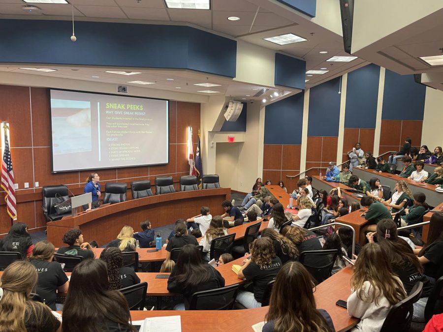 A student in a crowded lecture hall asks Herff Jones representative Ashley Cuervo a question on how to build a successful social media brand for ones news publication.