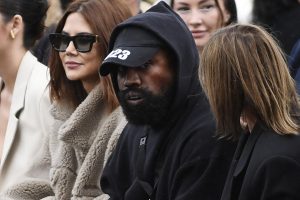 Kanye West, center, attends the Givenchy Spring-Summer 2023 fashion show during the Paris Womenswear Fashion Week on Oct. 2, 2022, in Paris.