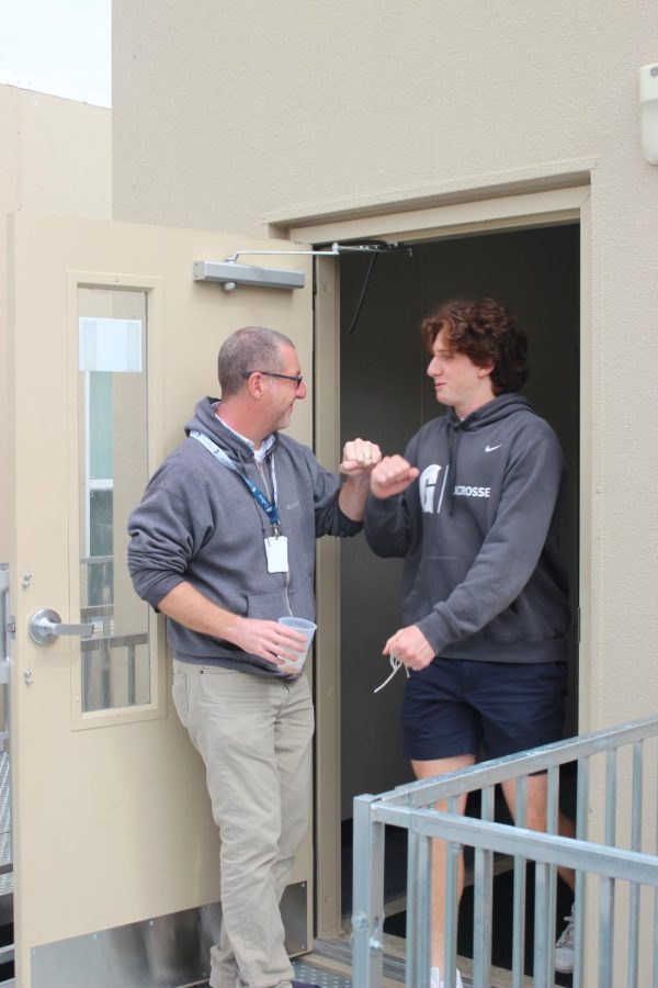 Junior Benji Berger leaves class and fist bumps Mr. Basterra on his way out.
