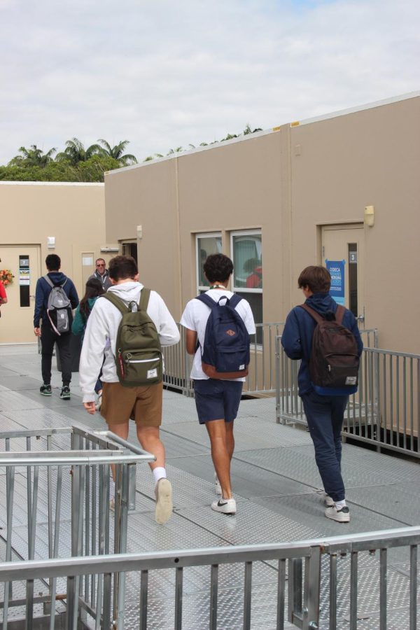 RIGHT ON TIME: Students walk to their class in the modular buildings. The mods are temporary replacements for classrooms that used to be in the church which has been torn down due to a new construction plan.