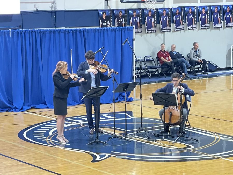 The Black Oak Ensemble, consisting of violinist Desirée Ruhstrat, Aurelien Pederzoli, and cellist David Cunliffe, perform their Silenced Voices album in front of upper school students and faculty. The trio were also scheduled to perform at the Marian C. Krutulis campus only an hour later.