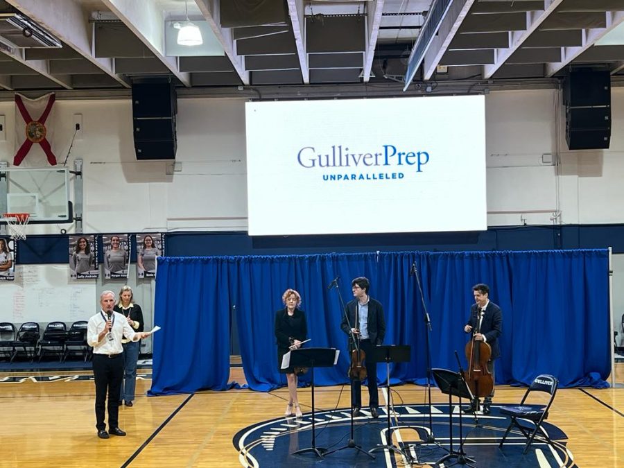 Head of Schools Frank Steel introduces the Black Oak Ensemble: consisting of  violinist Desirée Ruhstrat, Aurelien Pederzoli, and cellist David Cunliffe. The trio were also scheduled to perform their Silenced Voices album at the middle school only an hour later.