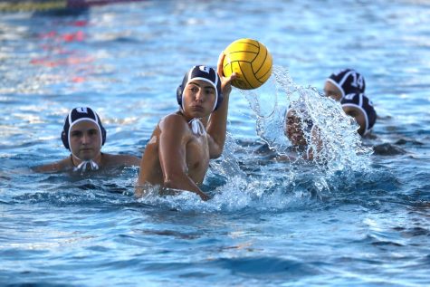 Sophomore Sebastian Piedra readies to attempt a shot into the goal during the match against Cutler Bay last Wednesday. The boys water polo team beat Cutler Bay 16-1.