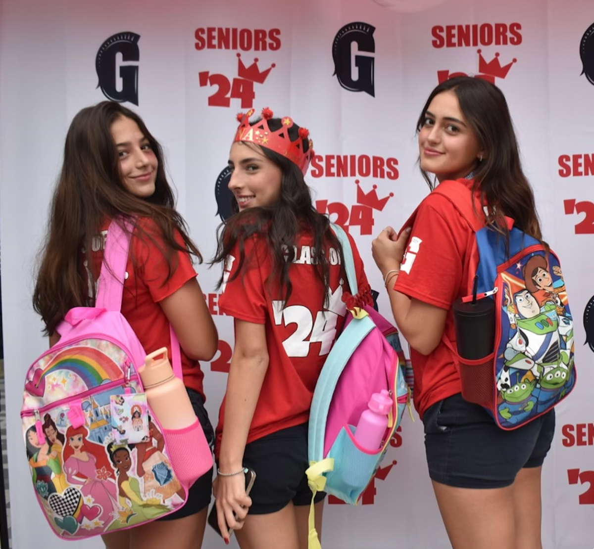 As+seniors+enter+school+for+their+last+first+day%2C+they+carry+the+one+thing+that+allows+them+to+reminisce+about+their+first+days+of+school%3A+character+backpacks.+Luciana+Hornstein%2C+Ana+Catherine+Guimaraes%2C+and+Sofia+Gershanik+showed+off+their+backpacks+in+front+of+the+senior+backdrop.+Seniors+were+excited+to+rock+backpacks+with+a+variety+of+childish+prints.+