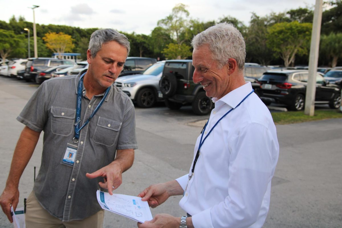 Dean of Students Tyrone Sandaal and Upper School Principal Jonathan Schoenwald overlook the maps handed out to parents to help them navigate the campus.
