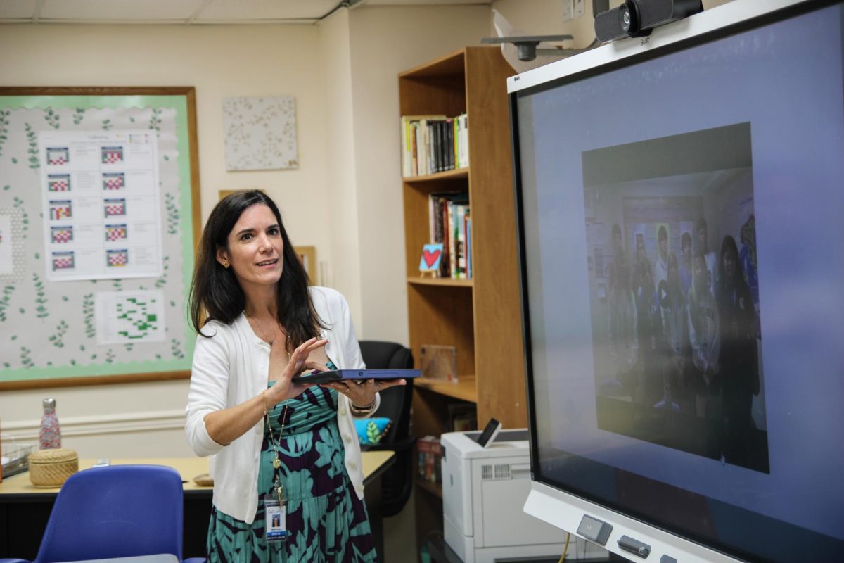Spanish teacher Maria Molina shows parents a message recorded by their kids.