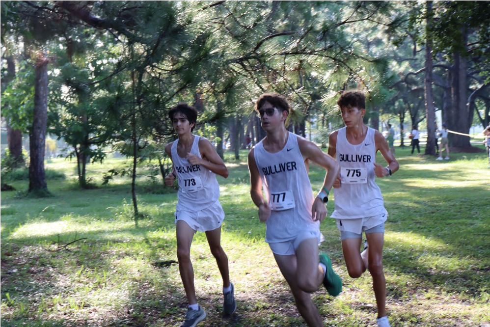Cross country runners push through the race at the St. Thomas University Bobcat Invitational. The Raiders finished fifth place for the boys, and eighth place for the girls. “This meet allowed us to see what shape we’re in and try to get better from here,” said freshman Emilio Perez. 