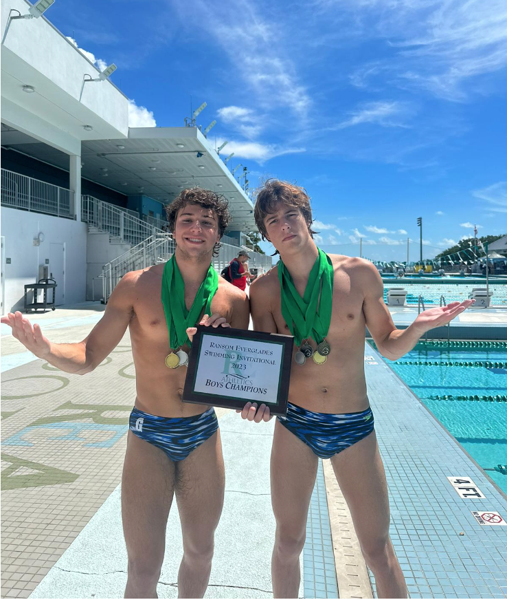 Captains Juanfransisco Gudino and Eduardo Kingston pose with the medals and the plaque they won in the RE Invite. The boys team placed first after their important victories in the last relay of the meet. The captains led the team to the win by motivating them in all the races.