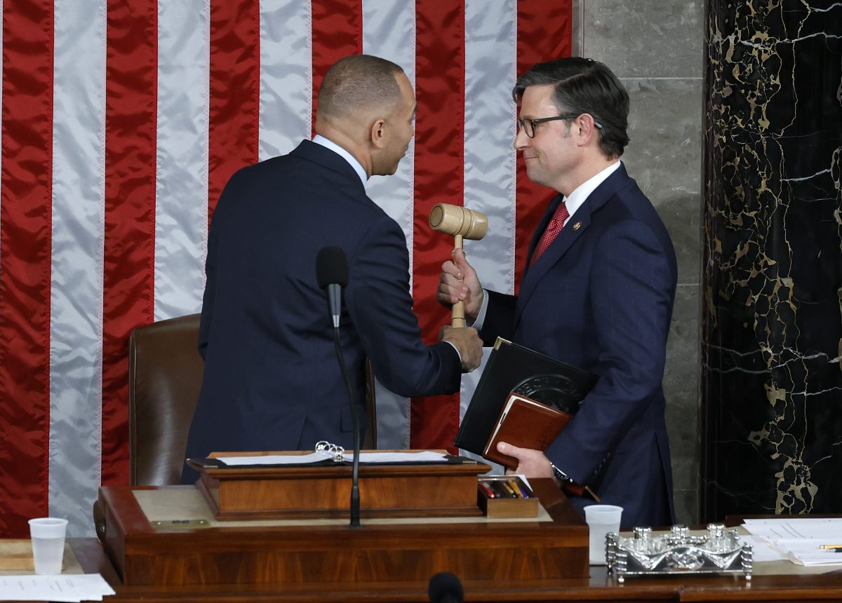 House Minority Leader Hakeem Jeffries (D-NY), left, hands the gavel to newly elected Speaker of the House Mike Johnson (R-LA) after the House of Representatives held an election in the U.S. Capitol on Wednesday, Oct. 25, 2023, in Washington, D.C. (Chip Somodevilla/Getty Images/TNS)
