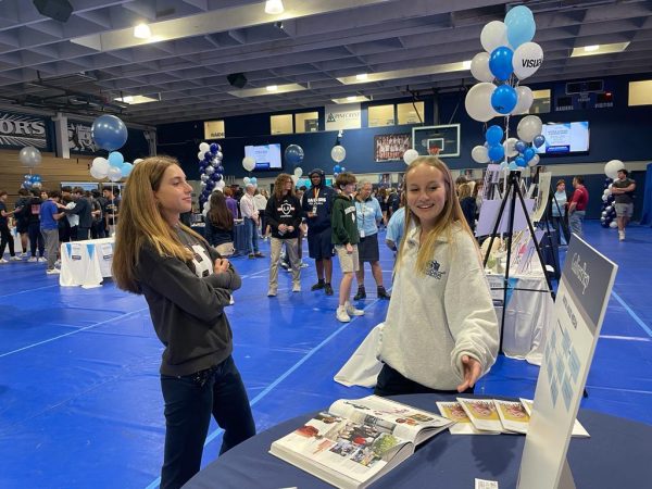 Students visit the Multimedia booth at the course Expo. The event allowed students to get a better understanding of their future path. Students went around different booths in the gym to explore the varieties of course options they might want to take. In each booth students and teachers were selected to represent their class and talk about it to others.