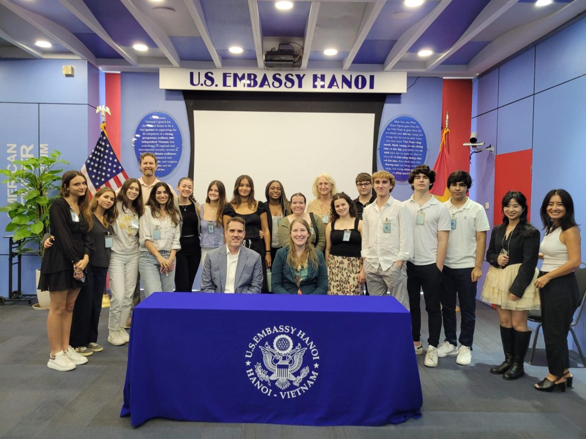 Students and teachers gather for a photo with representatives from the U.S. Embassy in Hanoi.