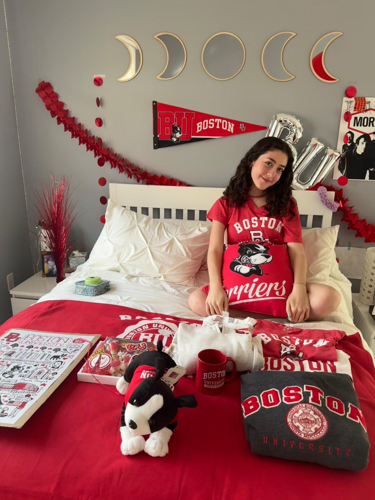 Senior Andrea Malpica celebrates her acceptance into Boston University. Malpicas family and friends decorated her bed with BU colors and merchandise  after she was accepted. (Sophi Massoumi)