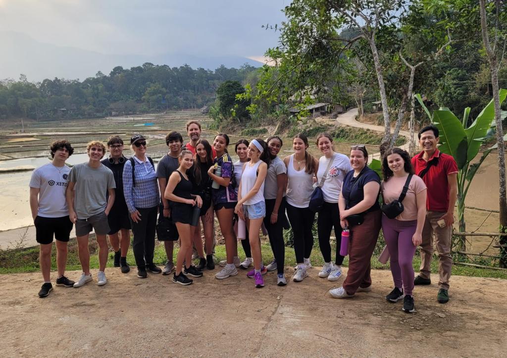 Students and faculty gather for a picture in front of a field of rice paddies in Mai Châu. The group took an hour and a half hike parallel to the rice paddies on the last day they visited the village. According to Barrett, the hike was one of the most bonding experiences alongside the groups work at Mai Châus hospital.