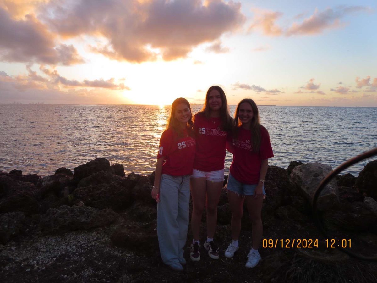 (Left to right) Seniors Kayla Alonso, Alexa Smith, and Ashley Garcia enjoy the view during the sunrise gathering at Matheson Hammock Park & Marina. The event, a long-standing school tradition known as Senior Sunrise, made for a memorable experience to kick off the 2024-25 school year. "I'll never forget this chapter of my life thanks to the best senior class ever," Alonso said.